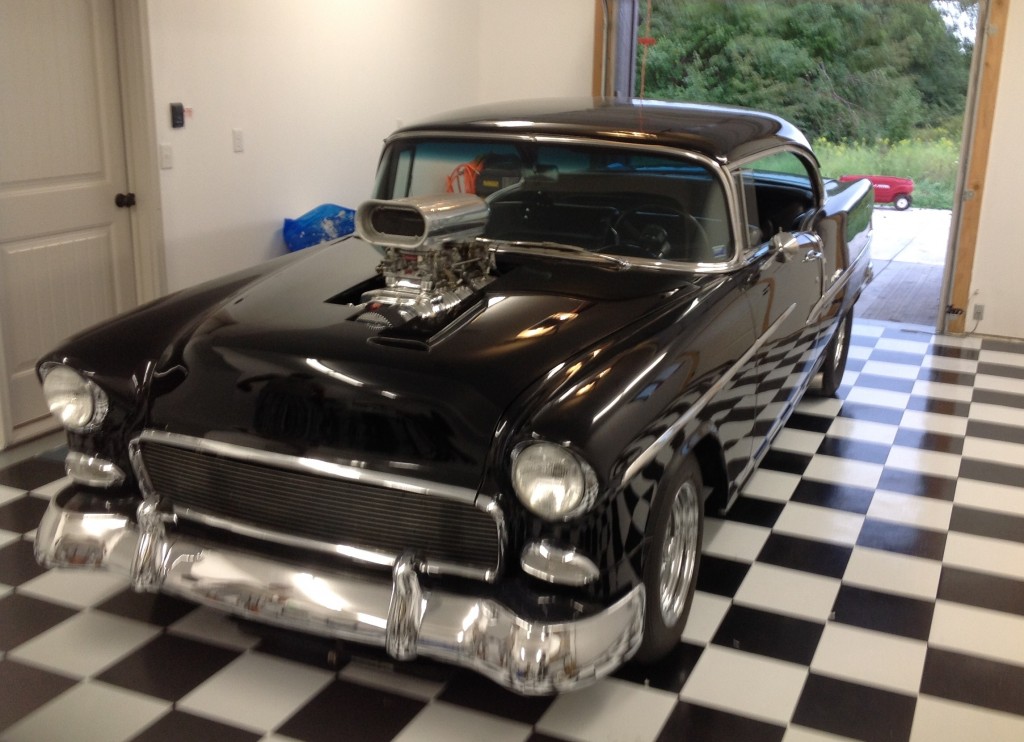 Classic car on checkerboard floor in garage